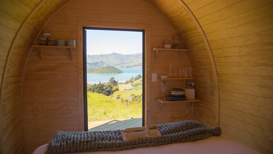 The view from the sleeping (Ruru) Pod. Each pod has an amazing view over the Onawe Peninsula. Waking to the dawn chorus, and experiencing it from your hot tub is something else.