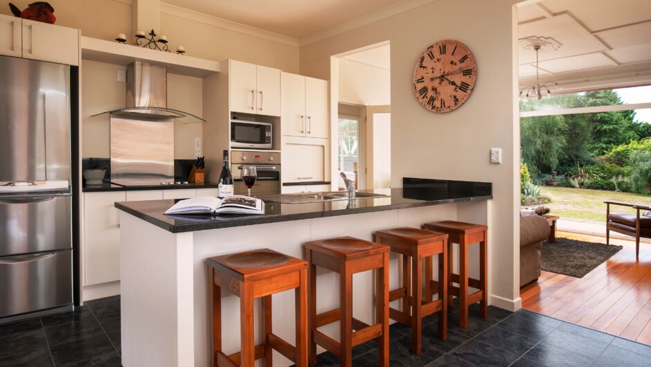 A fully renovated modern kitchen offers all the utensils and equipment for preparing great meals.