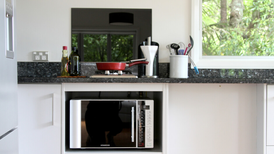 Kitchen area looks into the bush and out on to the deck.