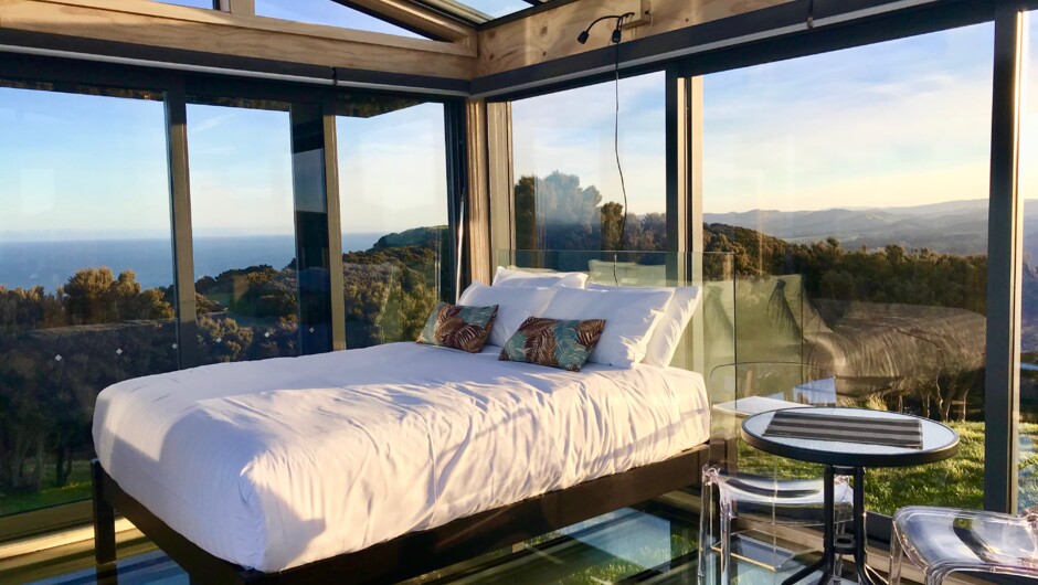 Glass walls, glass roof, glass floor - float in the beautiful landscape at the Atatū PurePod.