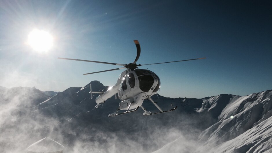 Helicopter in flight leaving hut