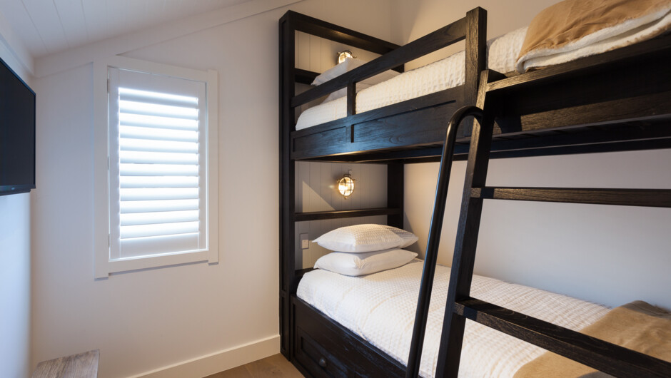 Barn two bunk beds with a personal TV for the children.