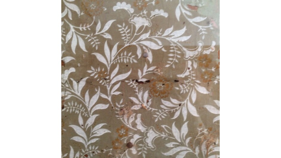 Original ninetenth century wallpaper discovered behind later wall coverings in the history room at Stoddart Cottage.