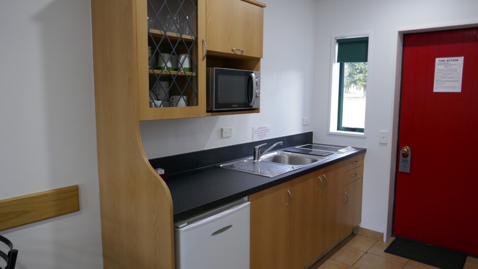 Kitchenette in every unit. Includes a 2 burner cooktop, refrigerator, microwave, kettle, toaster, dishes and utensils.