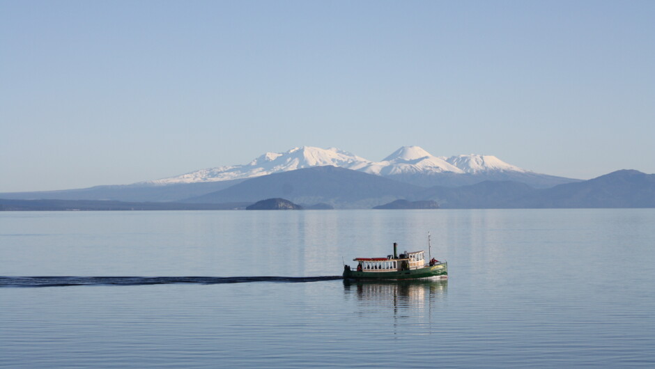 Ernest Kemp on a stunning spring day on Lake Taupō with the snow-covered mountains of the Tongariro National Park in the background